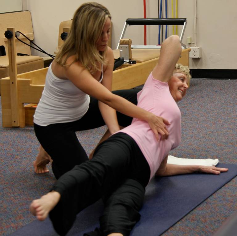 woman perfoming a pilates exercise