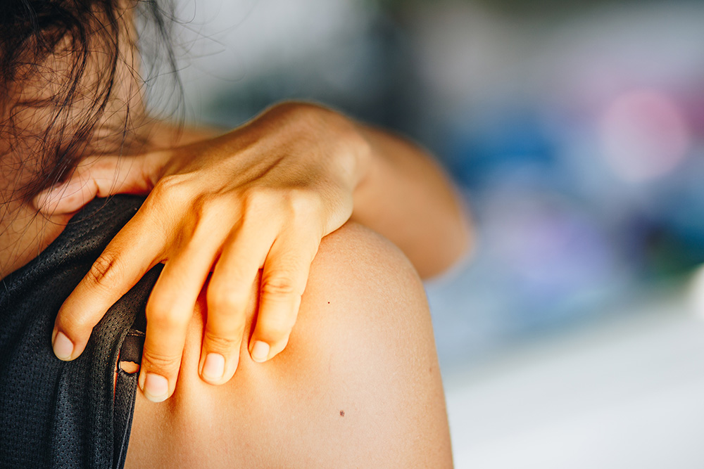 Asian woman with shoulder pain